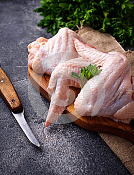 Raw chicken wings on cutting board