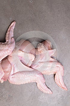 raw chicken wings on grey backgound