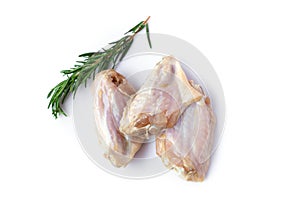 Raw chicken wings with rosemary isolated on white background