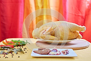 Raw chicken on a yellow background