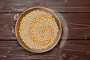 Raw chickpeas kabuli on brown wood