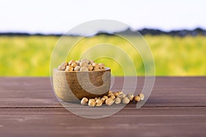 Raw chickpeas kabuli with field behind