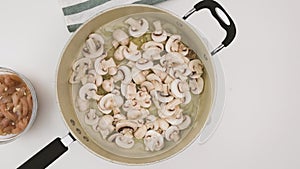 Raw chopped mushrooms on a frying pan close up