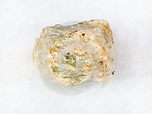 raw chrysoberyl (green beryl) crystal on white