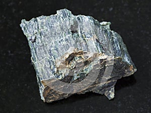 Raw chrysotile asbestos stone on dark