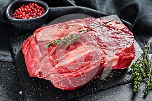 Raw Chuck eye roll steak. Organic beef. Black background. Top view