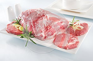Raw chuck steak with tableware photo