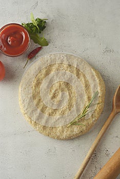 Raw circle dough. Pastry or bread dough. Bright background