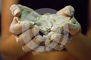 Raw clay in the hands of women