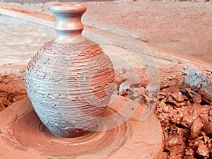 Raw clay vase with a narrow neck