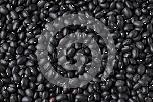 Raw close up black turtle beans background.