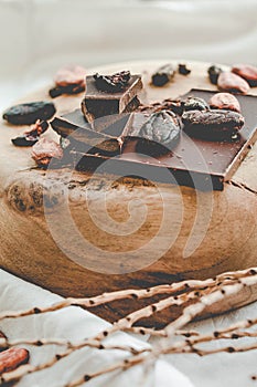 Raw cocoa cacao beans, black chocolate on brown sacking, top v