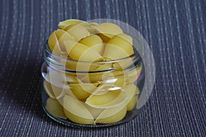 Raw Conchiglie Pasta in glass jar