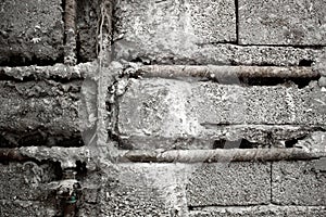 Raw concrete brick wall and water pipe background