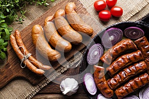 Raw and cooked sausage, pan, herbs and vegetables
