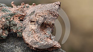 raw copper ore resting on a rock