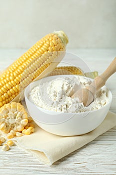 Raw corn and flour on white wooden