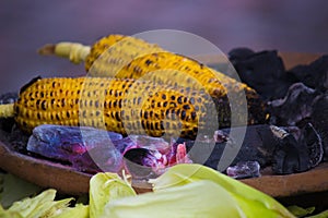 Raw Corn or Sweet Corn getting roasted or cooked on the coal during monsoons in steet of Hyderabad India