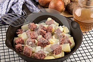 Raw corned beef hash in a cast iron pan