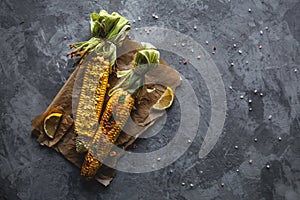 Raw Corns Freshly Picked with Green Cornhusk on Rustic Table Vintage Background Top View