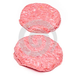 Raw crocodile meat burgers isolated on a white studio background