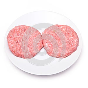 Raw crocodile meat burgers isolated on a white studio background