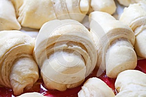 Raw croissant on the baking sheet ready to be cooked