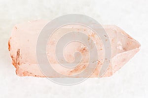 raw crystal of rose quartz gemstone on white