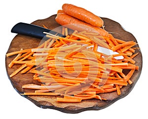 Raw cut carrot and ceramic knife on cutting board