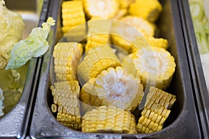 Raw cut of cron place in a metal tray ingredients prepared for the shabu shabu buffet