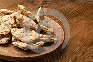 Raw Dehydrated Soy Meat or Soya Chunks on Wood Background