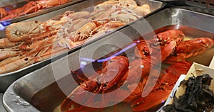 Raw delicious fresh seafood crabs, lobsters, crayfish, shrimps on ice on market store shop