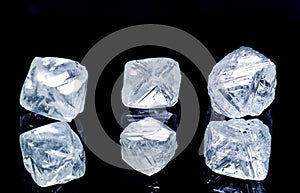 Raw diamonds isolated on black background.