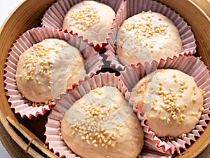 Raw dim sum buns in bamboo steamer