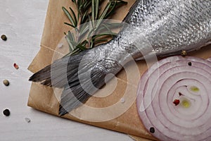 Raw dorado fish, spices and onion on white wooden table, flat lay