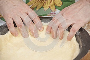 Raw dough in black metal baking form