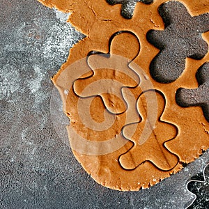 Raw dough forms baking gingerbread Christmas cookies dark background top view Copy space Flat lay christmas food concept