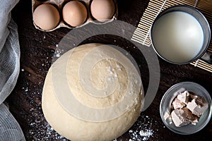 Raw dough and ingridients, food flat lay on kitchen table background