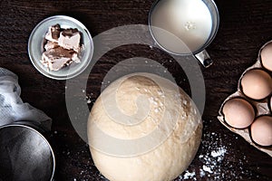 Raw dough and ingridients, food flat lay on kitchen table background
