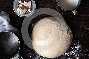 Raw dough and ingridients, food flat lay on kitchen table background