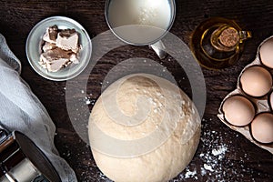 Raw dough and ingridients, food flat lay on kitchen table background