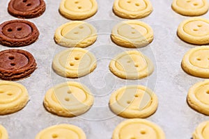 Raw dough. Yellow and brown cookies buttons