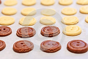 Raw dough. Yellow and brown cookies buttons