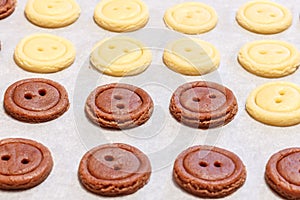 Raw dough. Yellow and brown cookies buttons