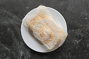 raw dry bihun or vermicelli or rice noodles or angel hair isolated on white background.