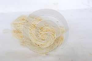 raw dry bihun or vermicelli or rice noodles or angel hair isolated on white background.