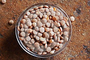 RAW DRY LENTILS IN A SMALL GLASS BOWL