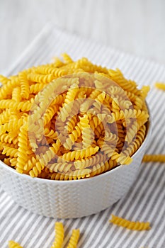 Raw Dry Organic Rotini Pasta Ready to Cook, low angle view. Close-up