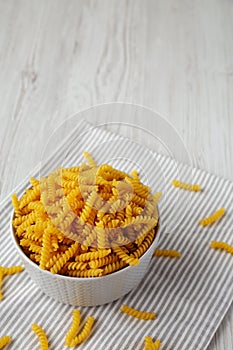 Raw Dry Organic Rotini Pasta Ready to Cook, side view. Copy space