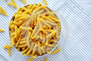 Raw Dry Organic Rotini Pasta Ready to Cook. Top view, from above, flat lay. Space for text